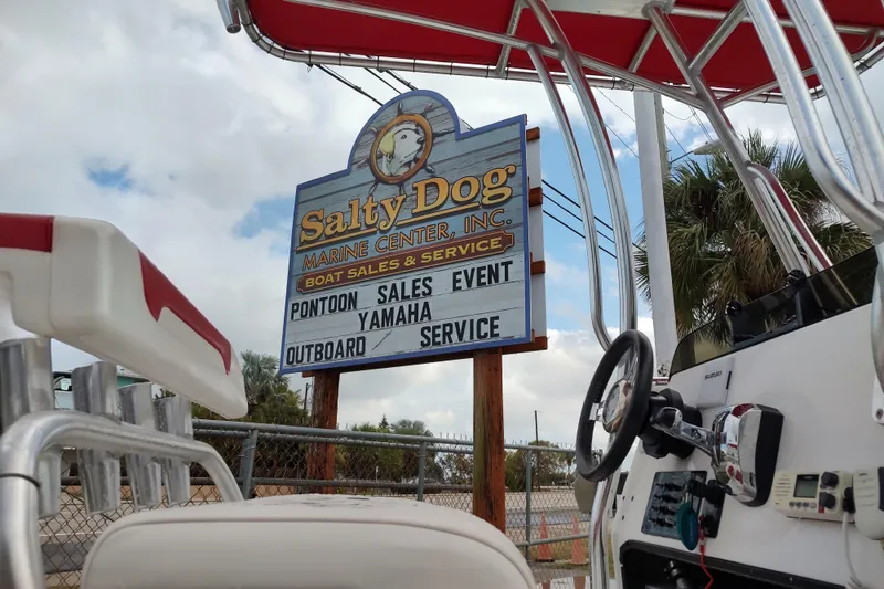 Slide: The Image of Boat dealership sign at Salty Dog Marine Center, featuring pontoon sales and Yamaha service. - 13