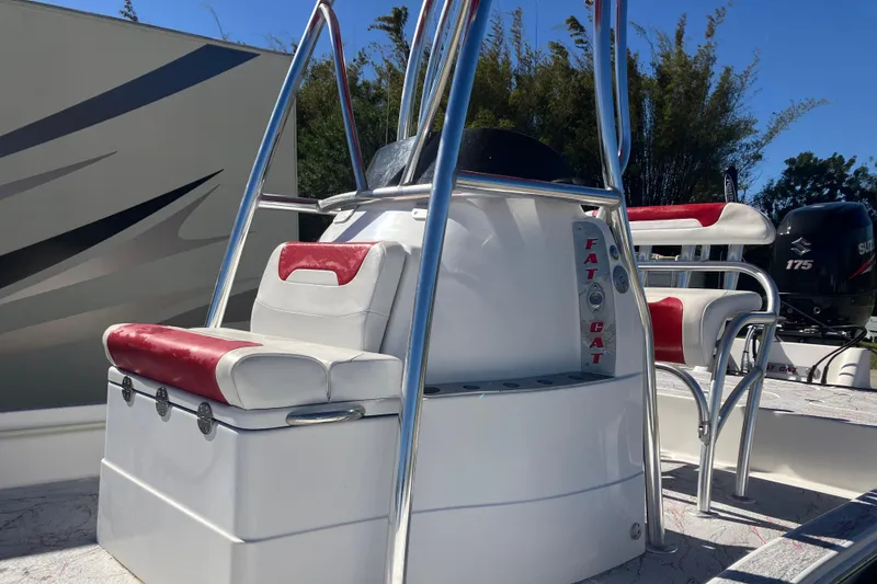 Slide: The Image of 2016 Fat Cat 21 boat with red and white seating, stainless steel frame, and Suzuki 175 engine. - 3