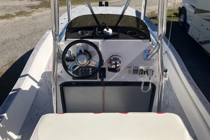 Slide: The Image of 2016 Fat Cat 21 boat dashboard with steering wheel and control panel. - 4