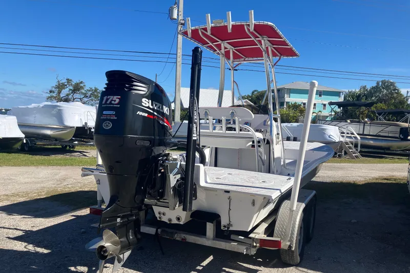 Slide: The Image of 2016 Fat Cat 21 boat with Suzuki 175 outboard motor, parked on a trailer. - 5
