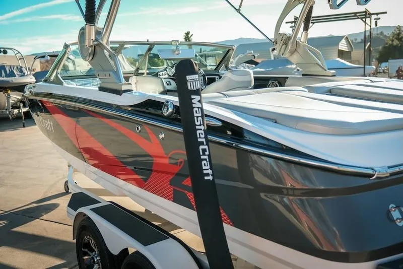 Slide: The Image of 2013 MasterCraft X-2 boat on trailer, featuring sleek design and vibrant graphics. - 10