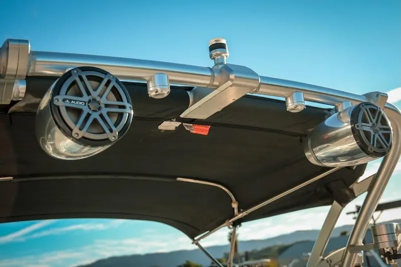 Slide: The Image of 2013 MasterCraft X-2 boat speakers and canopy under clear blue sky. - 15