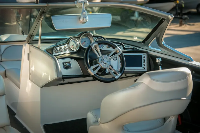 Slide: The Image of 2013 MasterCraft X-2 boat interior with steering wheel and dashboard controls. - 2