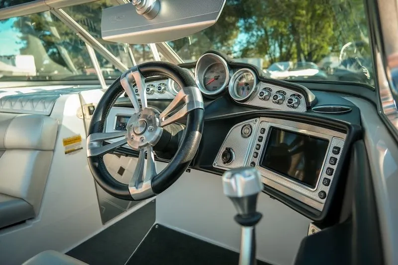 Slide: The Image of 2013 MasterCraft X-2 boat dashboard with steering wheel and control panel. - 21