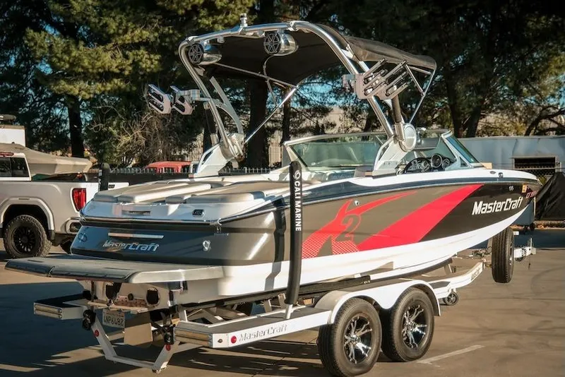 Slide: The Image of 2013 MasterCraft X-2 boat on trailer, featuring sleek design and vibrant graphics. - 8