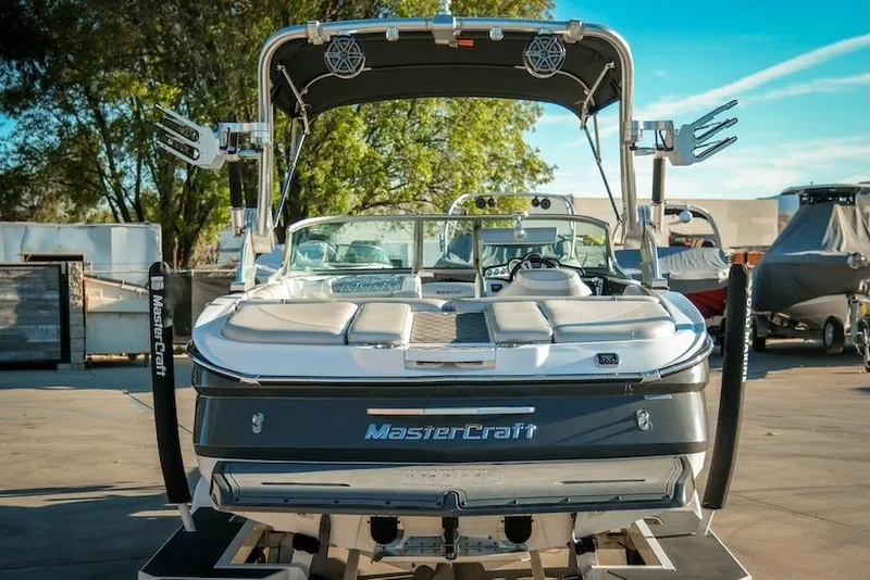 Slide: The Image of 2013 MasterCraft X-2 boat, rear view, parked outdoors on a sunny day. - 9