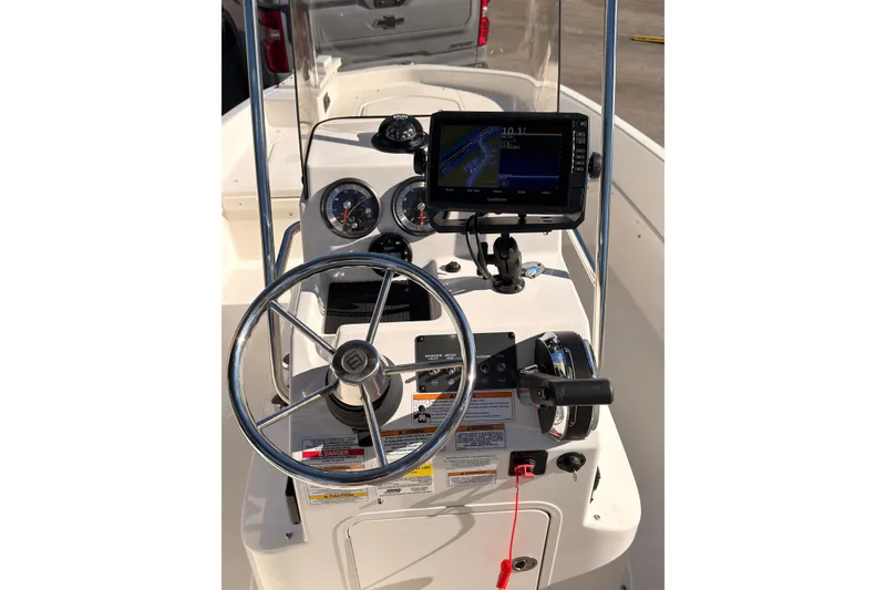 Slide: The Image of 2023 Trophy T-18 boat dashboard with steering wheel and navigation system. - 10