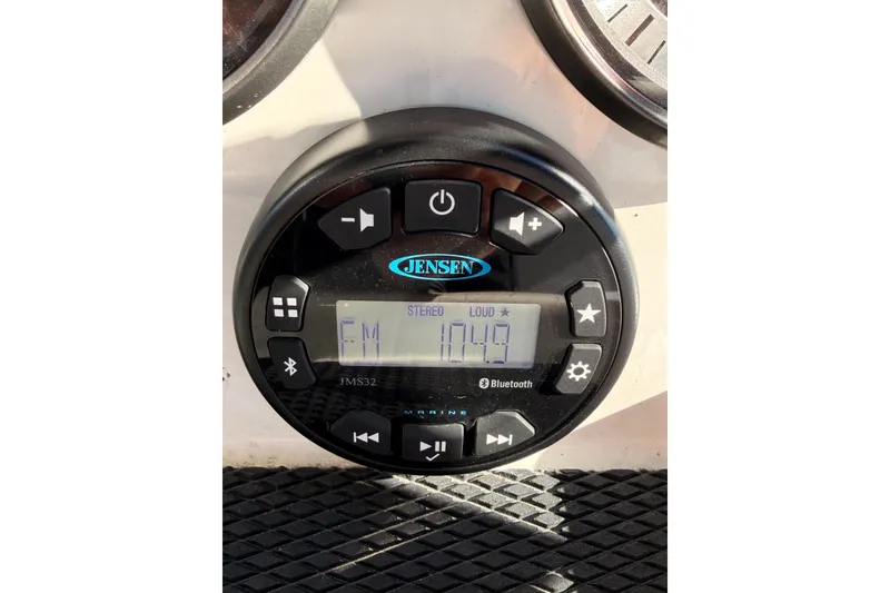 Slide: The Image of Jensen marine stereo system on Trophy T-18, 2023 model, displaying FM 104.9. - 12