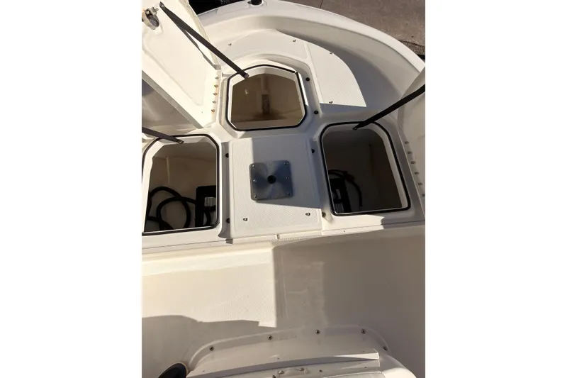 Slide: The Image of 2023 Trophy T-18 boat storage compartments with open hatches, showcasing interior space. - 16