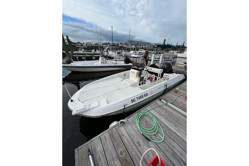 Slide: The Image of 2023 Trophy T-18 boat docked at marina, overcast sky, wooden pier. - 19