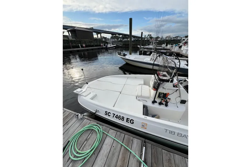 Slide: The Image of 2023 Trophy T-18 boat docked at marina with fishing gear. - 20