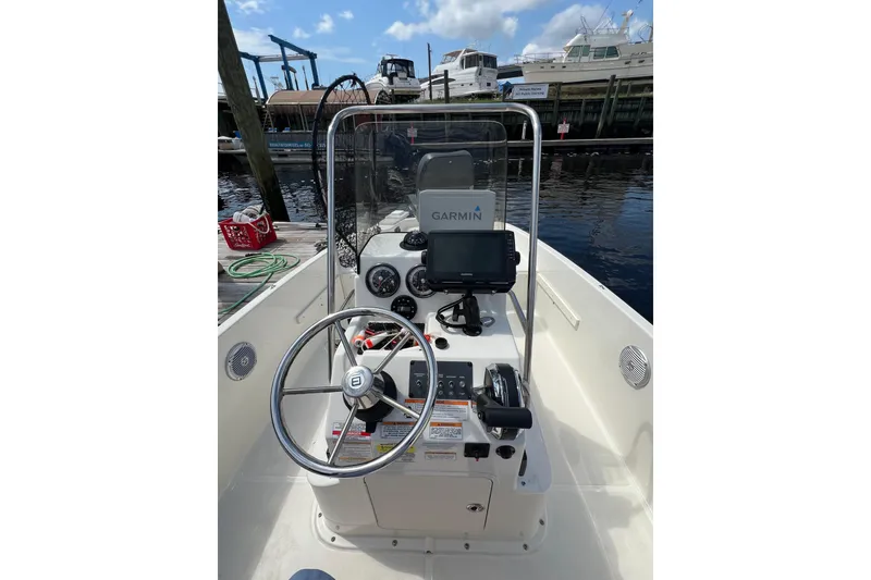 Slide: The Image of 2023 Trophy T-18 boat dashboard with Garmin navigation system at a marina. - 21