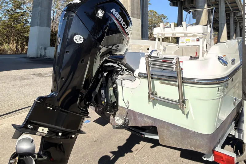 Slide: The Image of 2023 Trophy T-18 boat with Mercury outboard motor, parked under a bridge. - 3