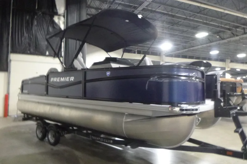 The Image of 2026 Premier 210 SunSation Angler 4 Point pontoon boat displayed indoors. - 1
