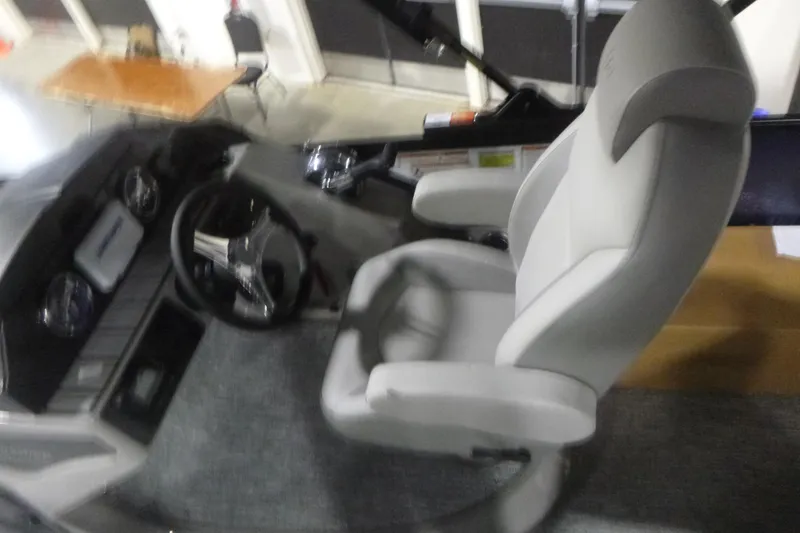 Slide: The Image of Interior of 2026 Premier 210 SunSation Angler 4 Point boat with steering wheel and seat. - 13