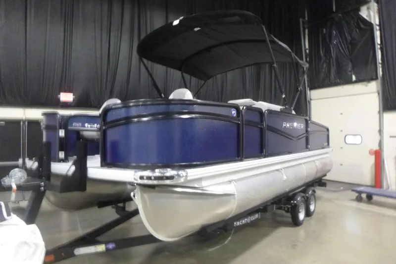 Slide: The Image of 2026 Premier 210 SunSation Angler 4 Point pontoon boat in showroom. - 3