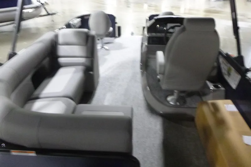 Slide: The Image of 2026 Premier 210 SunSation Angler 4 Point boat interior with gray seating and helm. - 6