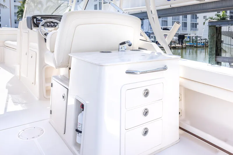 Slide: The Image of 2017 Grady-White Freedom 285 boat interior with helm and storage drawers. - 20