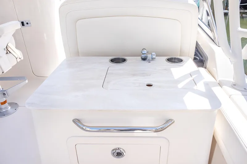Slide: The Image of 2017 Grady-White Freedom 285 boat interior with sink and storage area. - 22