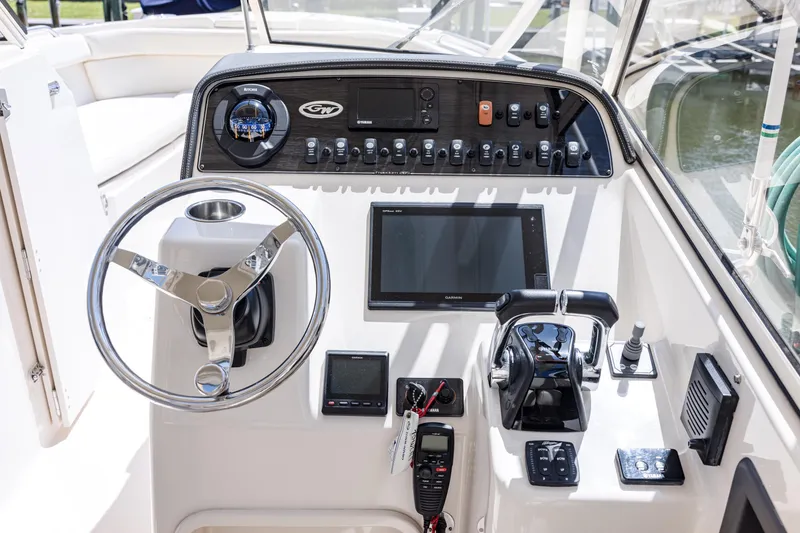 Slide: The Image of 2017 Grady-White Freedom 285 boat dashboard with steering wheel and control panel. - 24