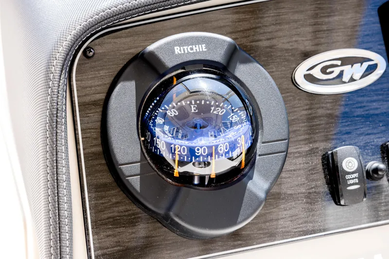 Slide: The Image of Compass on 2017 Grady-White Freedom 285 boat dashboard with GW logo. - 25