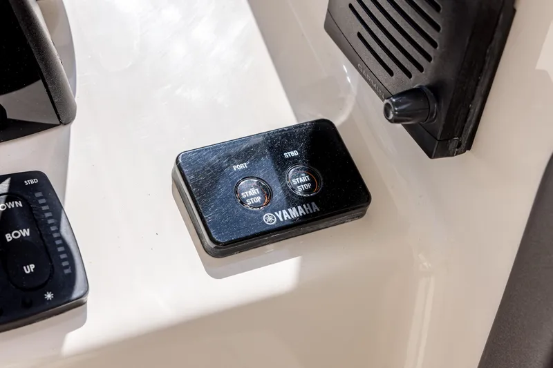 Slide: The Image of Yamaha start-stop control panel on 2017 Grady-White Freedom 285 boat dashboard. - 29