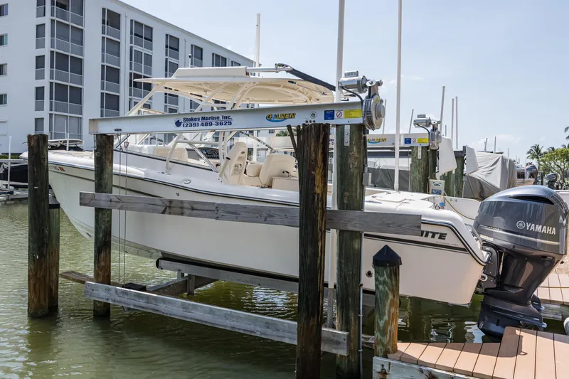 Slide: The Image of 2017 Grady-White Freedom 285 boat docked with Yamaha engine, near waterfront buildings. - 3