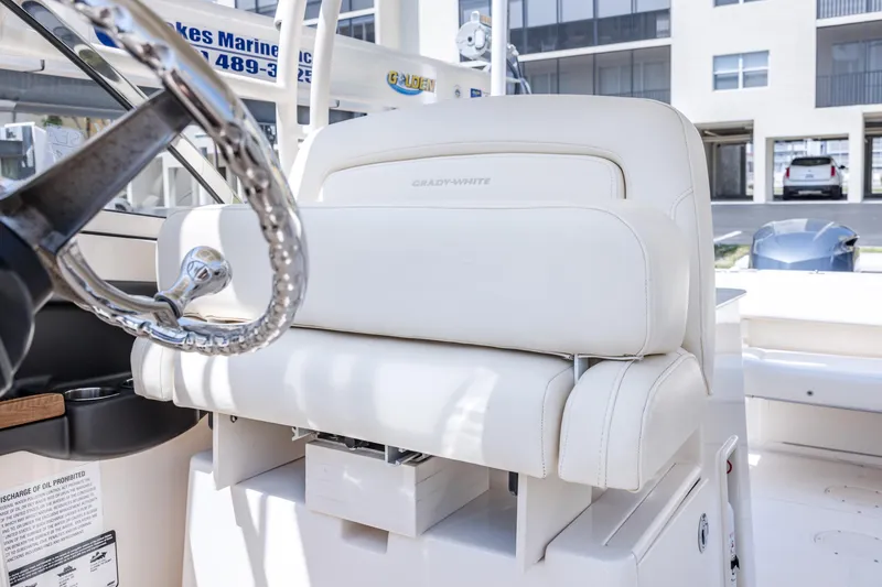 Slide: The Image of 2017 Grady-White Freedom 285 boat interior with steering wheel and white seating. - 31