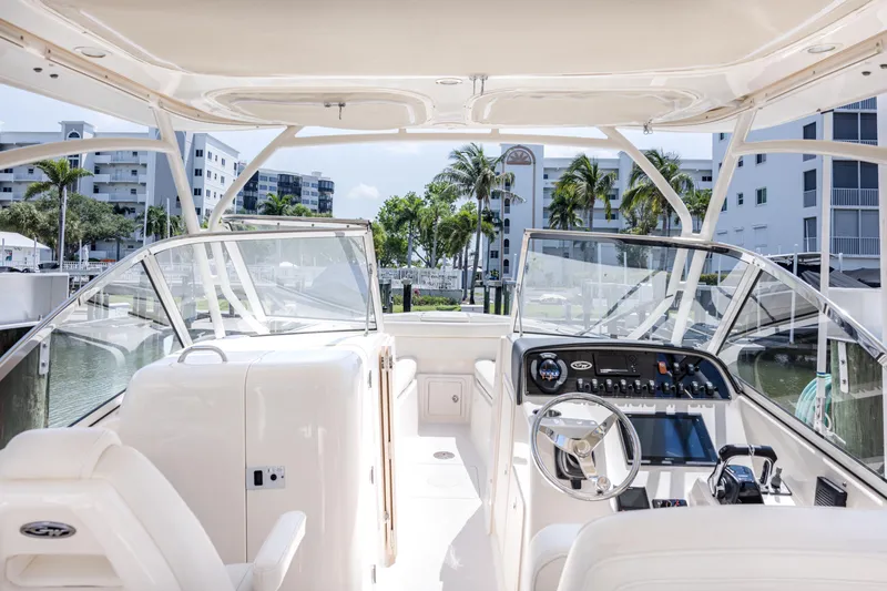 Slide: The Image of 2017 Grady-White Freedom 285 boat interior with modern dashboard and waterfront view. - 35