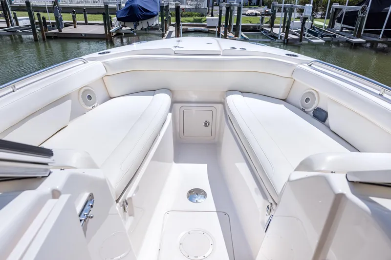Slide: The Image of 2017 Grady-White Freedom 285 boat interior with white seating and storage compartments. - 36