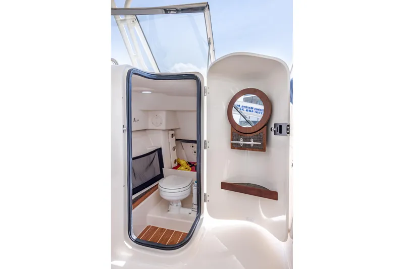 Slide: The Image of 2017 Grady-White Freedom 285 boat interior with toilet and mirror. - 40