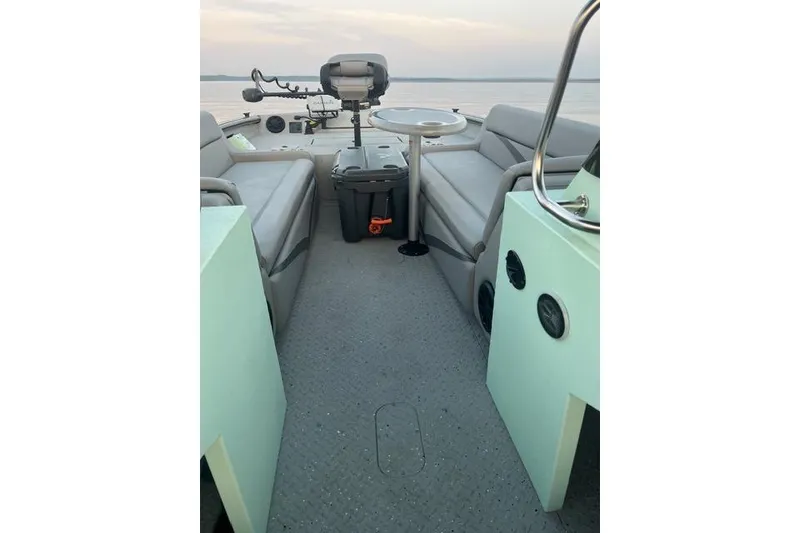 Slide: The Image of 2023 SeaArk Big Easy boat interior with seating and steering console. - 13