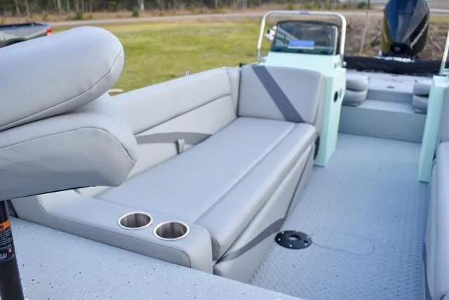 Slide: The Image of 2023 SeaArk Big Easy boat interior with gray seating and cup holders. - 3