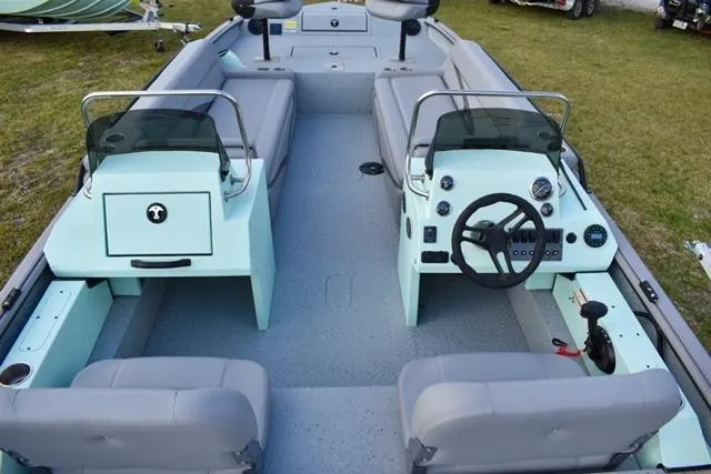 Slide: The Image of 2023 SeaArk Big Easy boat interior with dual consoles and seating, featuring a modern design. - 4