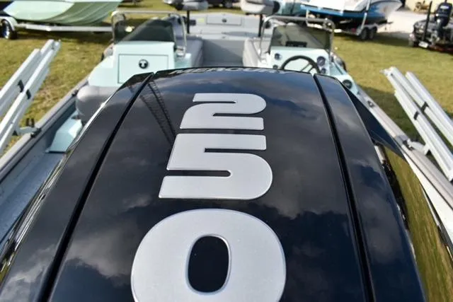 Slide: The Image of 2023 SeaArk Big Easy boat with 250 horsepower engine, displayed outdoors. - 5