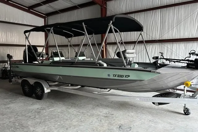 Slide: The Image of 2023 SeaArk Big Easy boat with canopy on trailer in storage facility. - 6