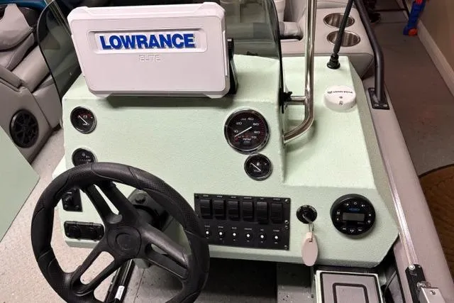 Slide: The Image of 2023 SeaArk Big Easy boat dashboard with Lowrance Elite system and steering wheel. - 7