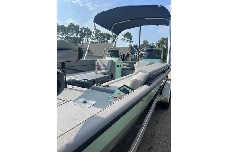 Slide: The Image of 2023 SeaArk Big Easy boat with canopy, spacious seating, and modern design. - 9