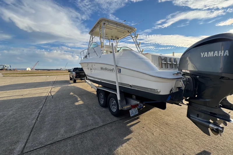 Slide: The Image of 2009 Wellcraft 270 Coastal O/B boat on trailer with Yamaha engine, parked on concrete. - 12