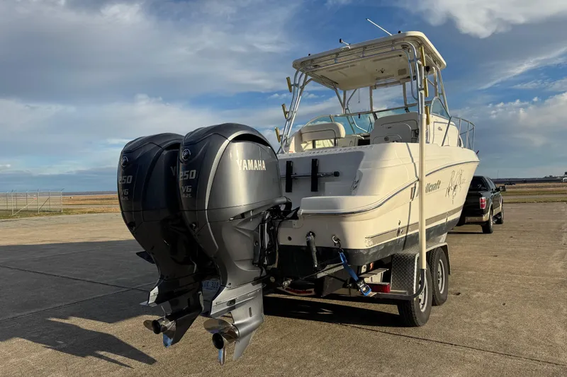 Slide: The Image of 2009 Wellcraft 270 Coastal O/B boat with twin Yamaha engines on a trailer. - 2
