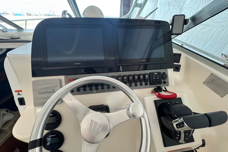Slide: The Image of 2009 Wellcraft 270 Coastal O/B helm with Garmin displays and steering wheel. - 20
