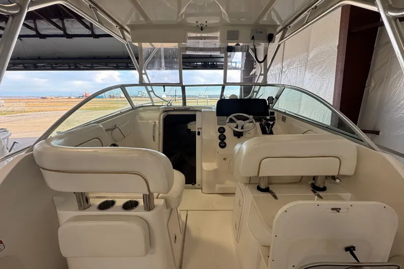 Slide: The Image of 2009 Wellcraft 270 Coastal O/B boat interior with helm, seating, and ocean view. - 22