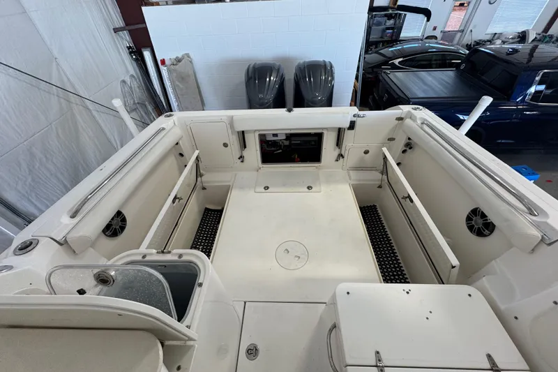 Slide: The Image of 2009 Wellcraft 270 Coastal O/B boat interior with storage compartments and seating. - 23