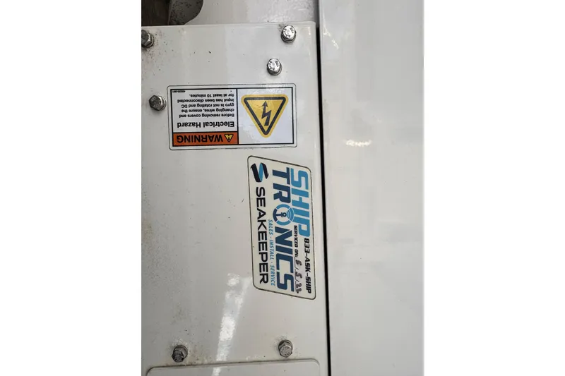 Slide: The Image of 2009 Wellcraft 270 Coastal O/B with Seakeeper and electrical hazard warning label. - 30