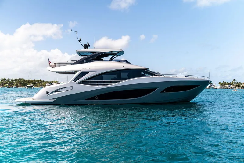 Slide: The Image of 2024 Aquitalia 78 Fly yacht cruising on clear blue water under a sunny sky. - 5