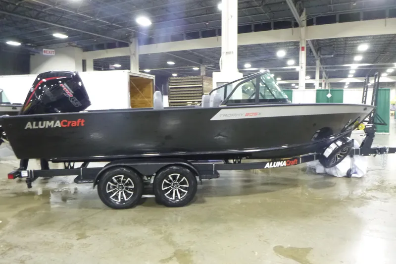 The Image of 2026 Alumacraft Trophy 205X Sport boat on display indoors, featuring sleek design and modern features. - 0