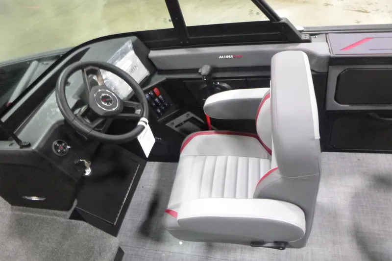 Slide: The Image of 2026 Alumacraft Trophy 205X Sport boat interior with steering wheel and captain's chair. - 10