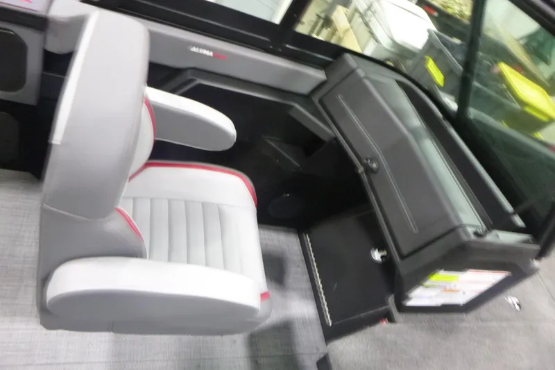 Slide: The Image of 2026 Alumacraft Trophy 205X Sport interior with gray seating and dashboard. - 12