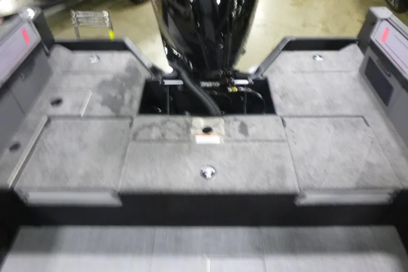 Slide: The Image of 2026 Alumacraft Trophy 205X Sport boat interior with gray flooring and engine compartment. - 14
