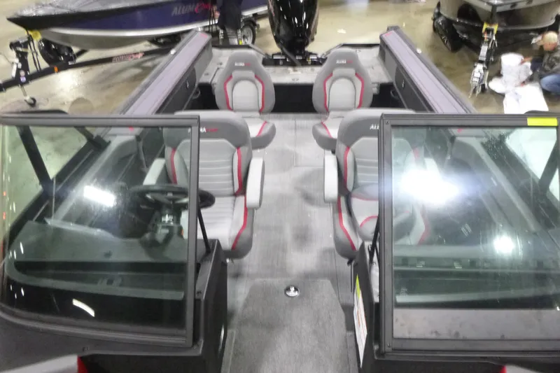 Slide: The Image of 2026 Alumacraft Trophy 205X Sport boat interior with seating and steering console. - 4
